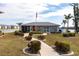 Charming community clubhouse featuring lush landscaping, a welcoming walkway, and nearby amenities at 3310 Loveland Blvd # 1808, Punta Gorda, FL 33980