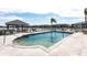 Relaxing community pool offers a gazebo, lounge chairs, and scenic lake views for enjoyable recreation at 3310 Loveland Blvd # 1808, Punta Gorda, FL 33980