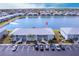 An aerial view of the condominium building with its manicured lawns, lakeside position, and ample parking at 3310 Loveland Blvd # 1808, Punta Gorda, FL 33980