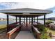 Community gazebo overlooking a serene lake, complete with picnic tables and a barbecue grill at 3310 Loveland Blvd # 1808, Punta Gorda, FL 33980