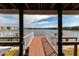 Inside the community gazebo, view of the serene lake framed by supportive beams at 3310 Loveland Blvd # 1808, Punta Gorda, FL 33980