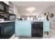 Kitchen view featuring an oven, dishwasher and blue colored cabinets at 3310 Loveland Blvd # 1808, Punta Gorda, FL 33980