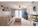 Inviting living room featuring a plush couch, decorative wall art, and a ceiling fan at 3310 Loveland Blvd # 1808, Punta Gorda, FL 33980
