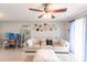 Comfortable living room with a large sectional sofa, ceiling fan, and lots of sunlight at 3310 Loveland Blvd # 1808, Punta Gorda, FL 33980
