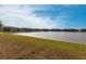 Scenic view of the tranquil pond surrounded by lush green lawn and well maintained condo buildings at 3310 Loveland Blvd # 1808, Punta Gorda, FL 33980