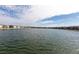 Expansive water view of the lake surrounding the community with a view of the condominium buildings in the background at 3310 Loveland Blvd # 1808, Punta Gorda, FL 33980