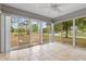 Sunroom with tile flooring surrounded by windows offering natural light and scenic views at 3391 Rogue St, North Port, FL 34291