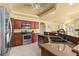 Modern kitchen features stainless steel appliances, dark wood cabinets, granite countertops, and an open design concept at 3601 Whippoorwill Blvd, Punta Gorda, FL 33950