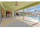 An expansive outdoor lanai with a screened enclosure overlooking the in-ground pool and canal at 3601 Whippoorwill Blvd, Punta Gorda, FL 33950