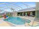 Relax by the pool in this expansive, screened lanai with white trim, stunning views, and access to the home at 3601 Whippoorwill Blvd, Punta Gorda, FL 33950