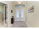 Bright foyer with tiled floor, shuttered doors, and transom window above the front doors at 3620 Carmichael Dr, Punta Gorda, FL 33950