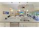Open concept kitchen and living room with sliding glass doors leading to outdoor seating area at 3620 Carmichael Dr, Punta Gorda, FL 33950