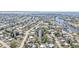 An aerial image showcasing a waterfront neighborhood with winding canals, single-Gathering homes, and mature trees at 3627 Easy St, Port Charlotte, FL 33952