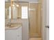 Bathroom features a glass-enclosed shower and vanity with neutral-toned tile at 3627 Easy St, Port Charlotte, FL 33952