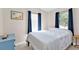 Comfortable bedroom featuring calming blue decor, natural light, and a tiled floor at 3627 Easy St, Port Charlotte, FL 33952