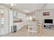 Open kitchen featuring bar seating, stainless steel appliances, and convenient access to the living room at 3627 Easy St, Port Charlotte, FL 33952