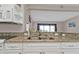 Modern kitchen with white cabinets, granite countertops, and stainless steel sink at 3627 Easy St, Port Charlotte, FL 33952