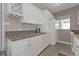 Bright kitchen featuring white cabinets, granite countertops, and modern appliances at 3627 Easy St, Port Charlotte, FL 33952
