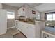 Well-lit kitchen featuring granite countertops, white appliances, and a view to the living area at 3627 Easy St, Port Charlotte, FL 33952