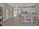 Bright open-concept living space featuring tile floors, bar seating, and an adjacent sunroom at 3627 Easy St, Port Charlotte, FL 33952