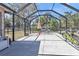 Spacious screened patio with seating, an umbrella, and easy access to the backyard at 3627 Easy St, Port Charlotte, FL 33952