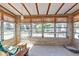 Sunroom featuring lots of windows, tile floors, and a relaxing seating area at 3627 Easy St, Port Charlotte, FL 33952