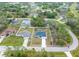 Aerial view of a single-story home with a long driveway, a two-car garage, and a well-kept lawn at 3700 Bobko Cir, North Port, FL 34291