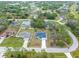 An aerial view of a home with a large front yard and well-maintained landscaping in a quiet neighborhood at 3700 Bobko Cir, North Port, FL 34291