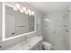 Bathroom with a large LED mirror, sleek vanity, and a tiled walk-in shower at 3744 Kingston Blvd, Sarasota, FL 34238