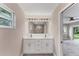 Bathroom featuring double vanity, modern fixtures, and a view of the shower at 3841 Cinderella Rd, North Port, FL 34286