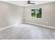 A bright empty bedroom with a ceiling fan and a window at 3841 Cinderella Rd, North Port, FL 34286