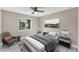 Neutral bedroom with a large window, soft lighting, and a gray chair at 3841 Cinderella Rd, North Port, FL 34286