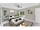 Bright bedroom featuring a ceiling fan, neutral walls, and a sliding glass door leading to the outdoors at 3841 Cinderella Rd, North Port, FL 34286