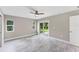 A bright empty bedroom with a ceiling fan and a glass door leading to the outside at 3841 Cinderella Rd, North Port, FL 34286