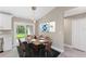 Dining room area with sliding door access to the backyard and modern chandelier at 3841 Cinderella Rd, North Port, FL 34286