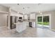 Modern kitchen with stainless steel appliances, white cabinets, and granite counters at 3841 Cinderella Rd, North Port, FL 34286