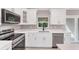 Modern kitchen featuring white cabinets, stainless steel appliances, and sleek countertops at 3841 Cinderella Rd, North Port, FL 34286