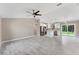 Open-concept living room with a kitchen, large window, and updated flooring at 3841 Cinderella Rd, North Port, FL 34286