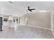 Open-concept living room featuring tile floors and modern lighting fixtures at 3841 Cinderella Rd, North Port, FL 34286