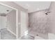 Bathroom highlighting modern tiled shower with seamless glass door and niche shelving at 3841 Cinderella Rd, North Port, FL 34286