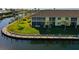 Aerial shot of waterfront condo building with boat docks, lush landscaping, and canal views at 4000 Bal Harbor Blvd # 316, Punta Gorda, FL 33950