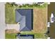 Aerial view of home, driveway, boat dock, canal and neighboring houses and landscaping at 430 Capri Isles Ct, Punta Gorda, FL 33950