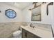 Nicely updated bathroom with new vanity, attractive mirror and lighting and unique octagon window at 430 Capri Isles Ct, Punta Gorda, FL 33950