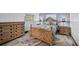 Comfortable bedroom with a wooden bed frame, matching nightstands, and a dresser at 430 Capri Isles Ct, Punta Gorda, FL 33950