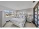 Bright bedroom with wicker furnishings, light wood floors and lots of natural light from two windows at 430 Capri Isles Ct, Punta Gorda, FL 33950