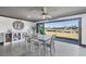Elegant dining area with canal views, a modern table set, and a decorative cabinet at 430 Capri Isles Ct, Punta Gorda, FL 33950