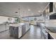 Modern kitchen with stainless steel appliances, a large island with a sink, and sliding doors to the backyard at 430 Capri Isles Ct, Punta Gorda, FL 33950