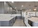 Bright kitchen featuring sleek appliances, stylish backsplash, and a large island with pendant lighting at 430 Capri Isles Ct, Punta Gorda, FL 33950
