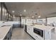Gourmet kitchen with stainless steel appliances, gray cabinets, a center island, and an open concept design at 430 Capri Isles Ct, Punta Gorda, FL 33950