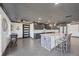 Spacious kitchen featuring gray cabinets, stainless steel appliances, a large island, and tile flooring at 430 Capri Isles Ct, Punta Gorda, FL 33950